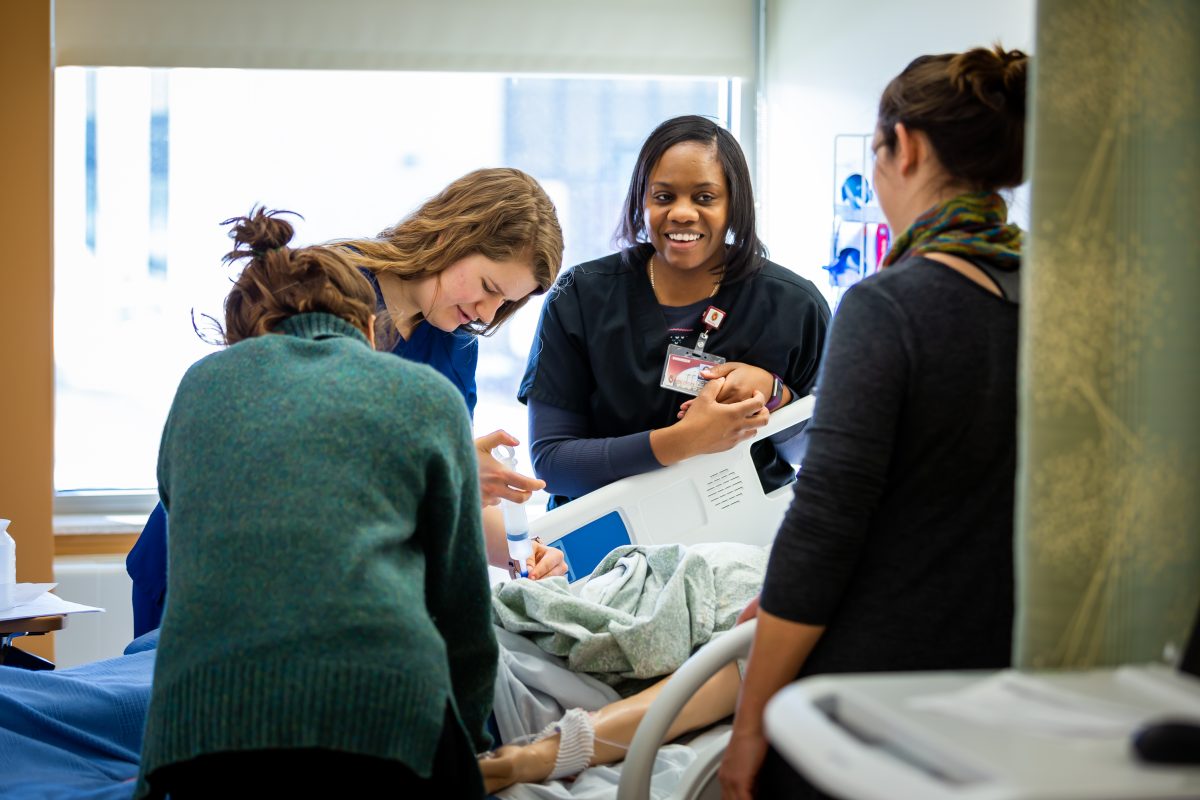 Students and Faculty working on simulation patient