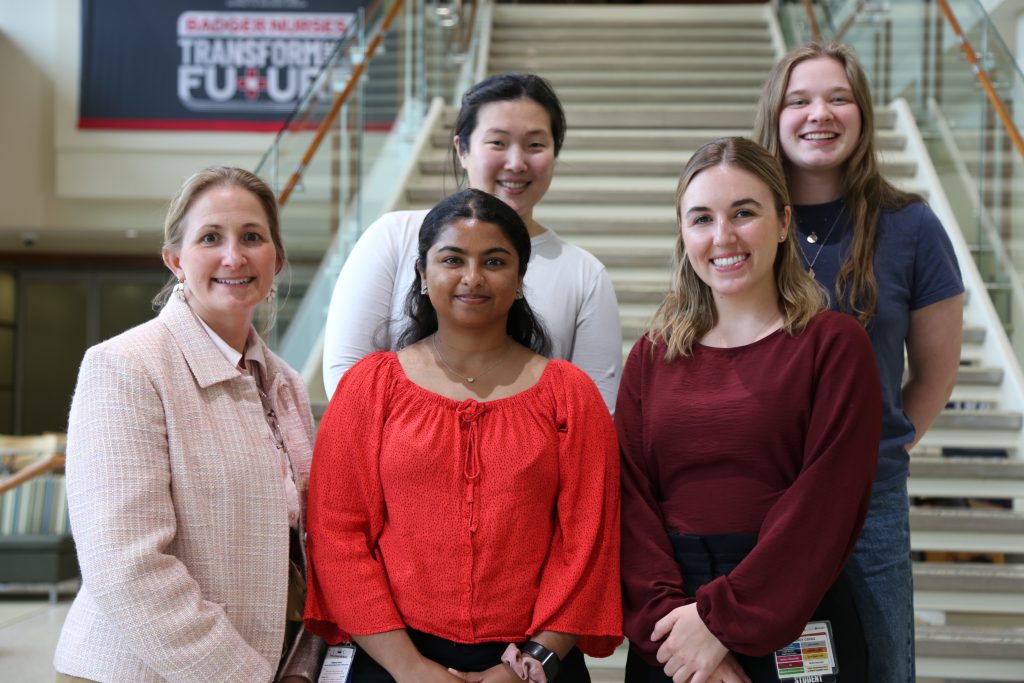 Image of four students and CIPE director standing.