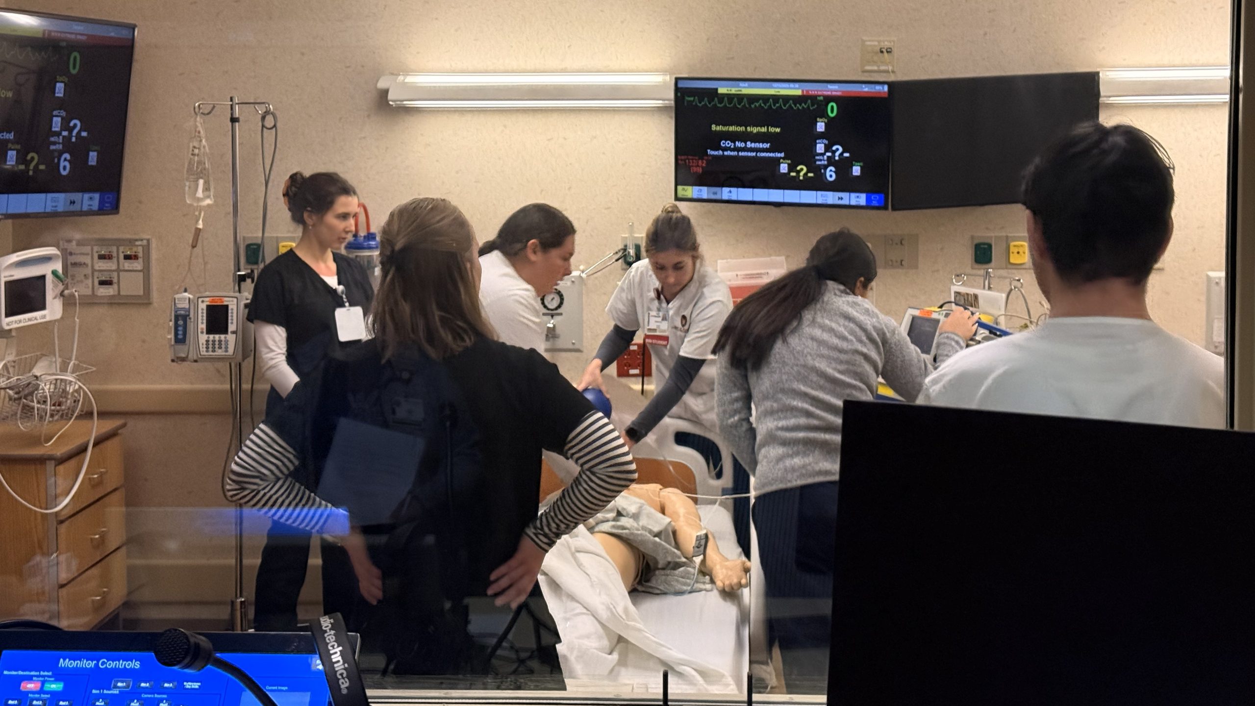 Students engaged in health simulation.