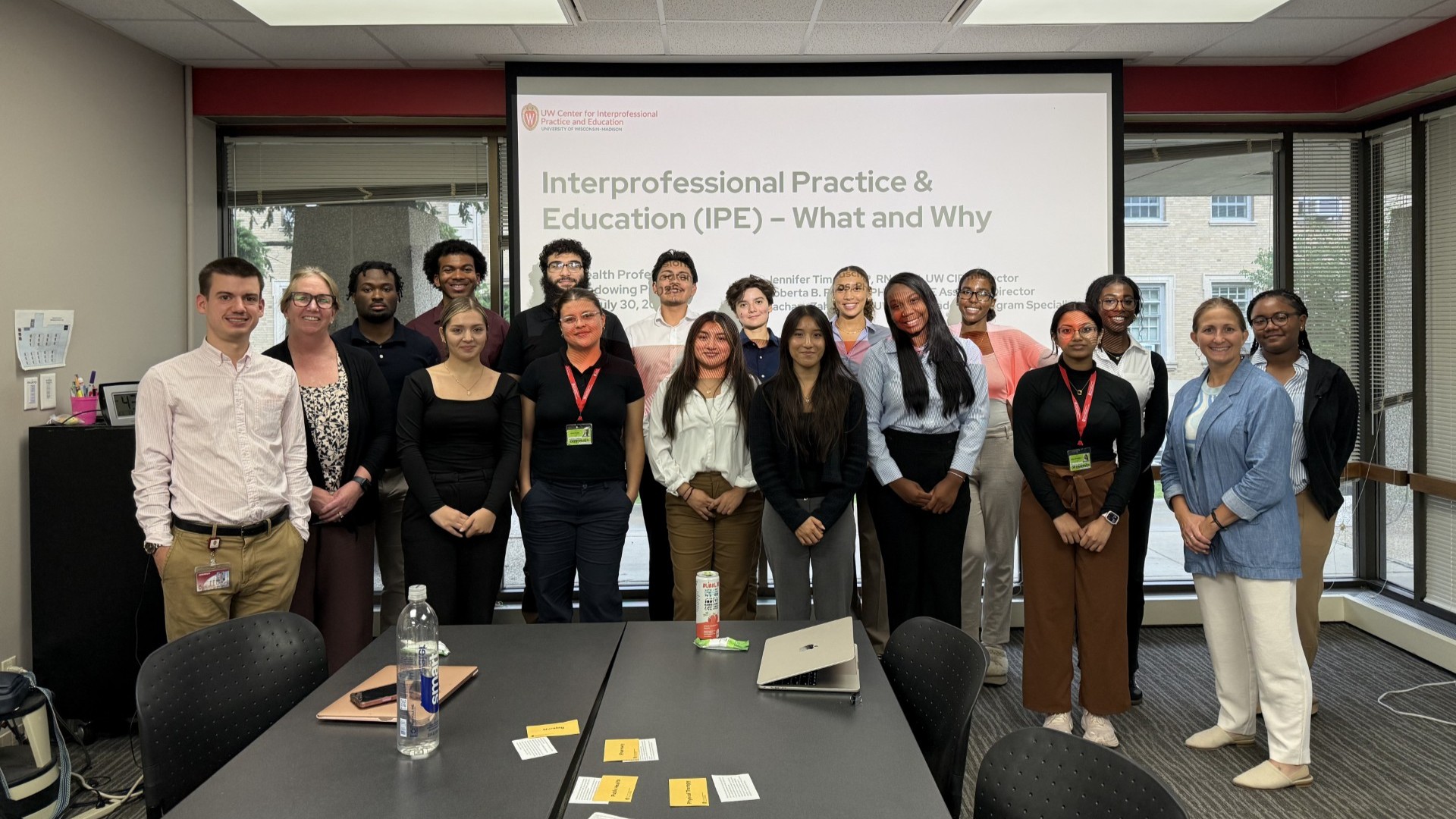 Students and staff standing and smiling.