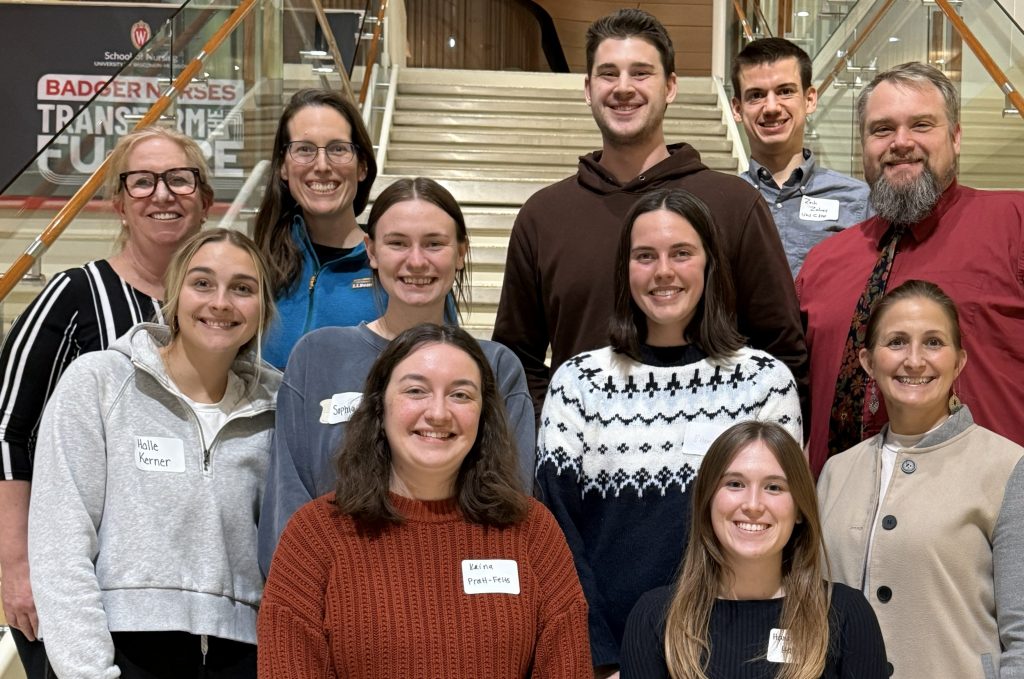 UW IPE PoD students and UW CIPE staff smiling on staircase.